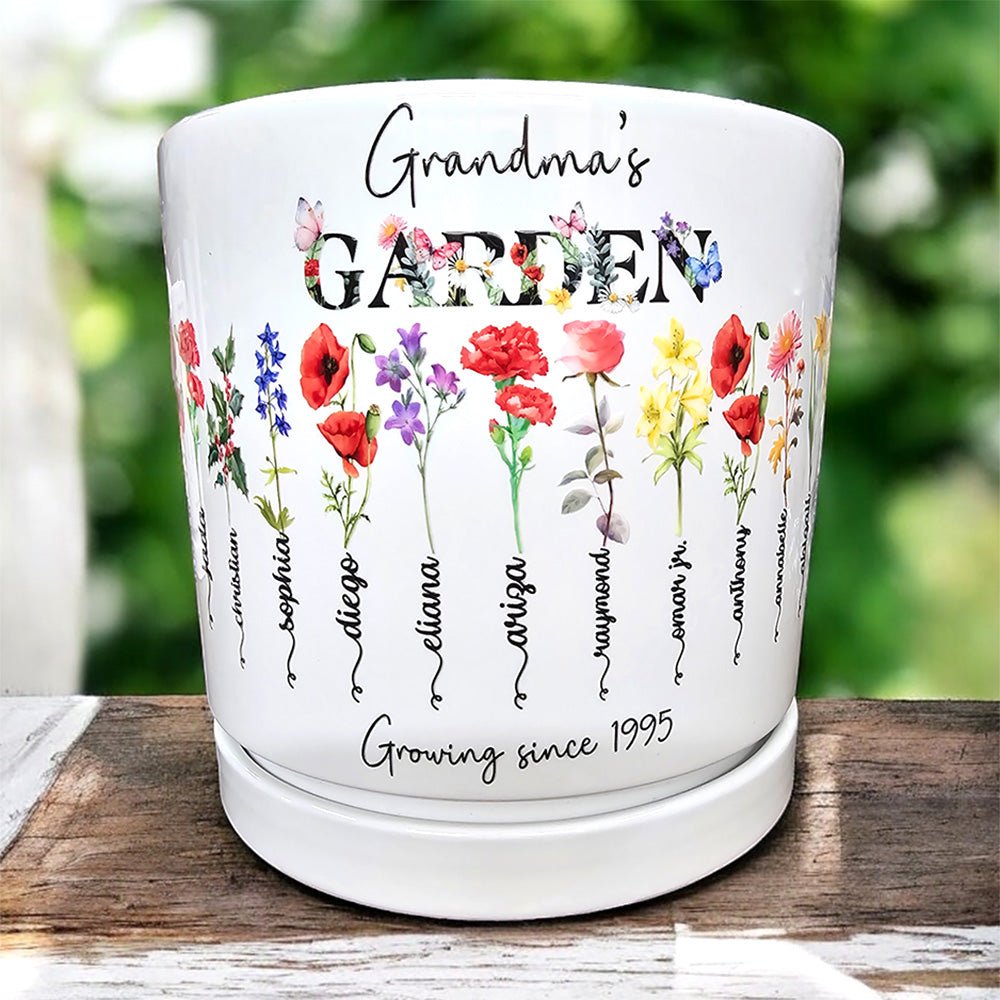 Personalized 'Grandma's Garden' white ceramic planter pot featuring custom watercolor birth flowers for grandchildren including Sophia, Diego, and Eliana, with the sentimental inscription 'Growing since 1995'.
