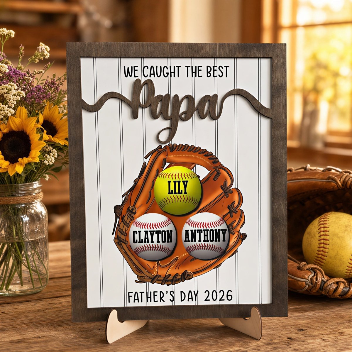 Personalized Father's Day baseball plaque for Papa. Features a rustic wood frame, 3D raised "Papa" lettering, and a printed baseball glove holding three custom kids' name balls, displayed on an easel.