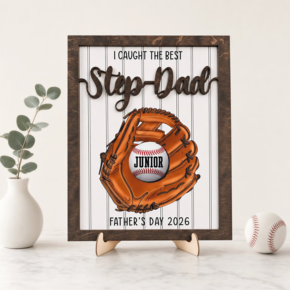 Personalized Father's Day baseball desk plaque for Stepdad. Custom wooden name sign featuring a 3D baseball glove, rustic frame, and a customized baseball displayed on an easel stand.