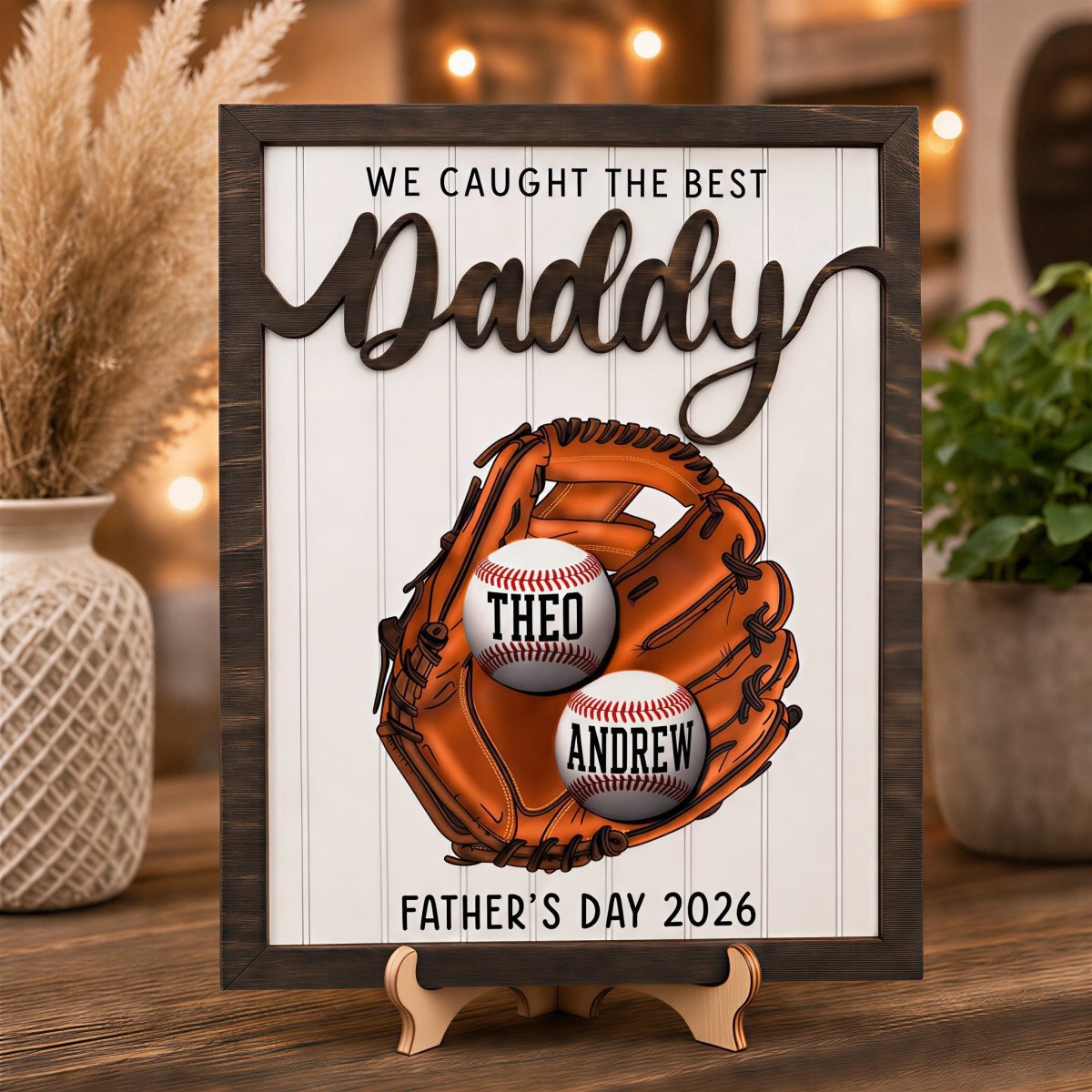 Personalized Father's Day baseball plaque for Daddy. Features a rustic wood frame, 3D raised "Daddy" lettering, and a printed baseball glove holding two custom kids' name baseballs, displayed on an easel.