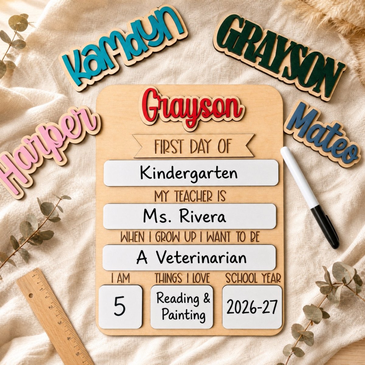 Personalized rounded top first day of school sign with interchangeable name pieces flat lay on linen — Kamryn, Grayson, Harper, Mateo options shown